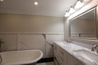 This cottage style bungalow surrounded by a white picket fence on Evergreen Hills Golf Course in Michigan - for sale on GolfHomes.com, golf home, golf lot