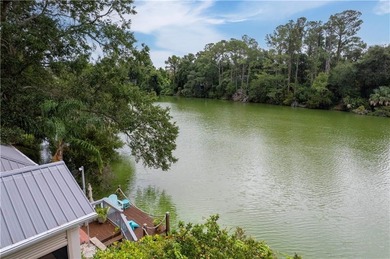 This charming and comfortable bungalow offers beautiful views of on Sea Island Golf Club in Georgia - for sale on GolfHomes.com, golf home, golf lot