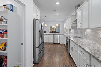 Pristine 2024 Mid-South Club home on an elevated lot with thick on Mid South Club in North Carolina - for sale on GolfHomes.com, golf home, golf lot