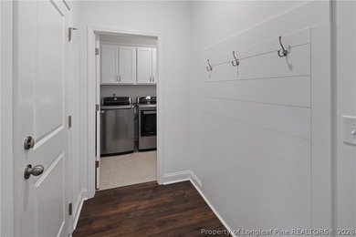 Pristine 2024 Mid-South Club home on an elevated lot with thick on Mid South Club in North Carolina - for sale on GolfHomes.com, golf home, golf lot