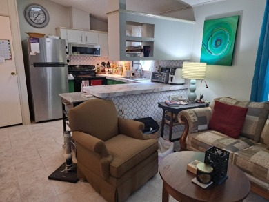 Located in a very active 55+ community close to shopping on Golden Lakes Golf Course in Florida - for sale on GolfHomes.com, golf home, golf lot