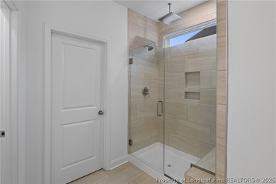 Pristine 2024 Mid-South Club home on an elevated lot with thick on Mid South Club in North Carolina - for sale on GolfHomes.com, golf home, golf lot