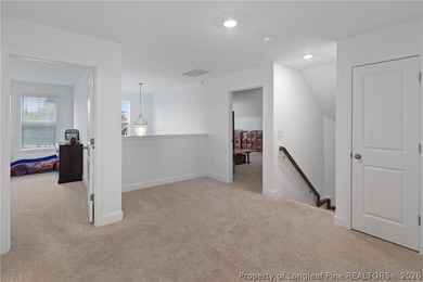 Pristine 2024 Mid-South Club home on an elevated lot with thick on Mid South Club in North Carolina - for sale on GolfHomes.com, golf home, golf lot