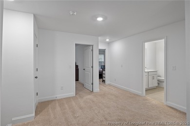 Pristine 2024 Mid-South Club home on an elevated lot with thick on Mid South Club in North Carolina - for sale on GolfHomes.com, golf home, golf lot