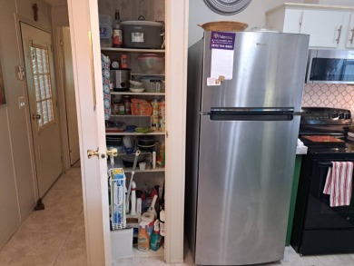 Located in a very active 55+ community close to shopping on Golden Lakes Golf Course in Florida - for sale on GolfHomes.com, golf home, golf lot