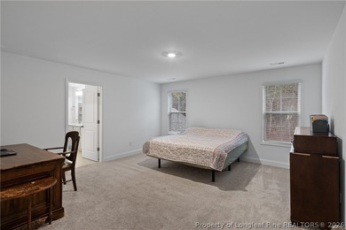 Pristine 2024 Mid-South Club home on an elevated lot with thick on Mid South Club in North Carolina - for sale on GolfHomes.com, golf home, golf lot