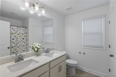 Pristine 2024 Mid-South Club home on an elevated lot with thick on Mid South Club in North Carolina - for sale on GolfHomes.com, golf home, golf lot