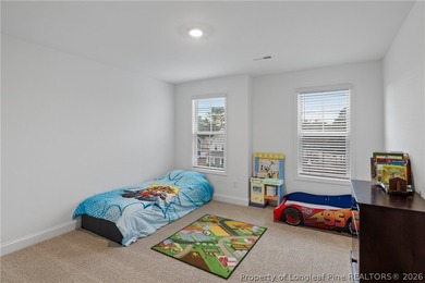 Pristine 2024 Mid-South Club home on an elevated lot with thick on Mid South Club in North Carolina - for sale on GolfHomes.com, golf home, golf lot