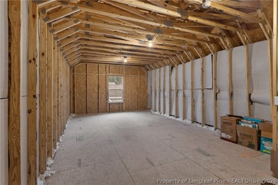 Pristine 2024 Mid-South Club home on an elevated lot with thick on Mid South Club in North Carolina - for sale on GolfHomes.com, golf home, golf lot