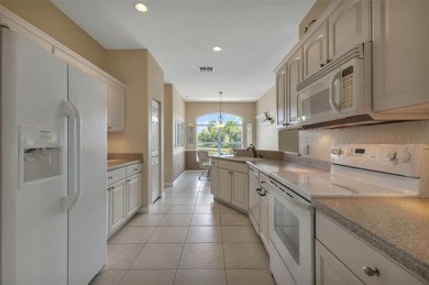 SENSATIONAL WATER VIEW from a MASSIVE enclosed and tiled lanai on Kings Gate Golf Club in Florida - for sale on GolfHomes.com, golf home, golf lot