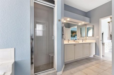 SENSATIONAL WATER VIEW from a MASSIVE enclosed and tiled lanai on Kings Gate Golf Club in Florida - for sale on GolfHomes.com, golf home, golf lot