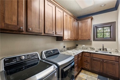 This custom estate sits on a rare 1.4-acre wooded lot backing to on The Traditions Club At Texas A and M in Texas - for sale on GolfHomes.com, golf home, golf lot