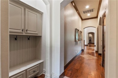 This custom estate sits on a rare 1.4-acre wooded lot backing to on The Traditions Club At Texas A and M in Texas - for sale on GolfHomes.com, golf home, golf lot