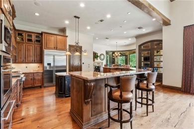 This custom estate sits on a rare 1.4-acre wooded lot backing to on The Traditions Club At Texas A and M in Texas - for sale on GolfHomes.com, golf home, golf lot