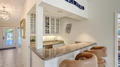 Coastal elegance meets island living in Bay Isles Bayou on on Longboat Key Golf Club Resort in Florida - for sale on GolfHomes.com, golf home, golf lot