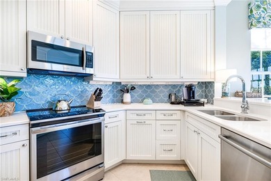 This stunning southern-exposure end unit offers some of the most on West Bay Beach and Golf Club in Florida - for sale on GolfHomes.com, golf home, golf lot