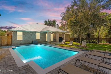 Nestled on an oversized lot, this single-level brick home in on Santa Rosa Golf and Beach Club in Florida - for sale on GolfHomes.com, golf home, golf lot
