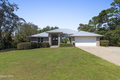Nestled on an oversized lot, this single-level brick home in on Santa Rosa Golf and Beach Club in Florida - for sale on GolfHomes.com, golf home, golf lot