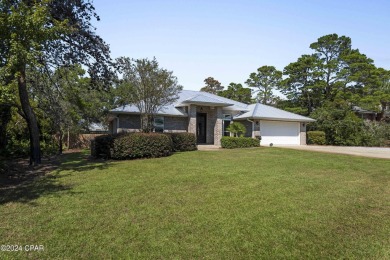 Nestled on an oversized lot, this single-level brick home in on Santa Rosa Golf and Beach Club in Florida - for sale on GolfHomes.com, golf home, golf lot