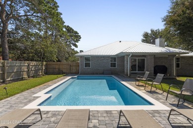 Nestled on an oversized lot, this single-level brick home in on Santa Rosa Golf and Beach Club in Florida - for sale on GolfHomes.com, golf home, golf lot