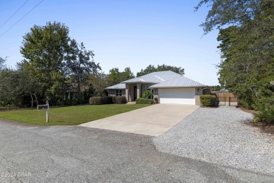 Nestled on an oversized lot, this single-level brick home in on Santa Rosa Golf and Beach Club in Florida - for sale on GolfHomes.com, golf home, golf lot