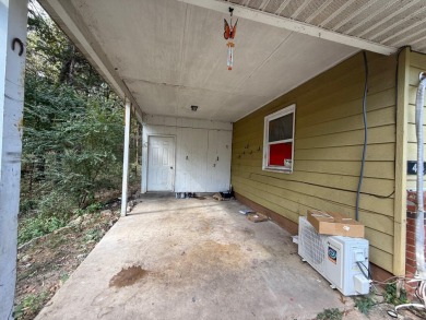 This 3-bedroom, 2-bath home sits on a large corner lot and on Cherokee Village North Course in Arkansas - for sale on GolfHomes.com, golf home, golf lot