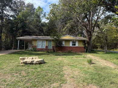 This 3-bedroom, 2-bath home sits on a large corner lot and on Cherokee Village North Course in Arkansas - for sale on GolfHomes.com, golf home, golf lot