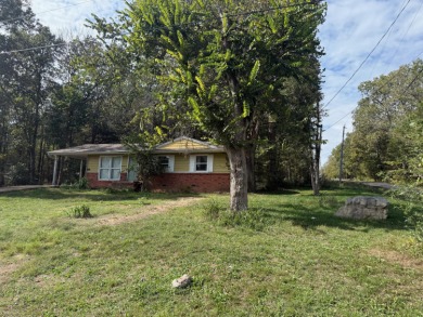 This 3-bedroom, 2-bath home sits on a large corner lot and on Cherokee Village North Course in Arkansas - for sale on GolfHomes.com, golf home, golf lot