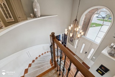 Discover luxurious lakefront living in this beautifully on Indianwood Golf and Country Club in Michigan - for sale on GolfHomes.com, golf home, golf lot