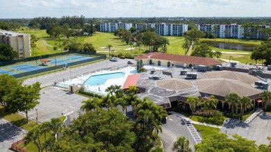CONVENIENTLY LOCATED ACROSS FROM THE CLUBHOUSE & 2 POOLS, THIS on Poinciana Golf Club in Florida - for sale on GolfHomes.com, golf home, golf lot