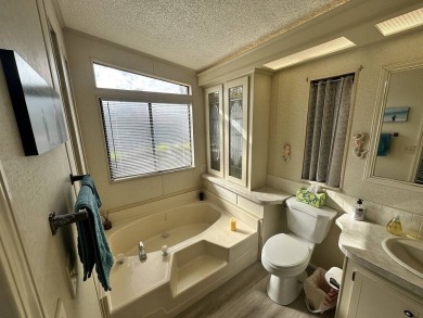 Lot Rent for this home is $1,342.00/monthly. Beautiful stucco on Del Tura Golf and Country Club in Florida - for sale on GolfHomes.com, golf home, golf lot