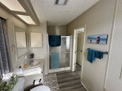 Lot Rent for this home is $1,342.00/monthly. Beautiful stucco on Del Tura Golf and Country Club in Florida - for sale on GolfHomes.com, golf home, golf lot