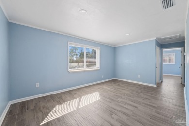 Discover an incredible opportunity to own a 4-bedroom brick home on Tiger Point Golf and Country Club in Florida - for sale on GolfHomes.com, golf home, golf lot