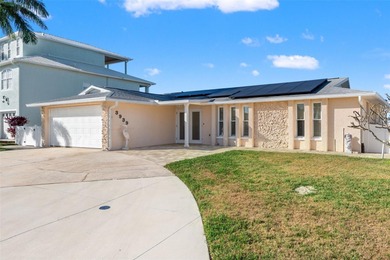 Wake up every morning to shimmering canal views, step out onto on Gulf Harbors Golf Course in Florida - for sale on GolfHomes.com, golf home, golf lot