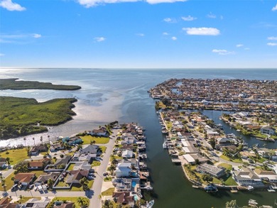 Wake up every morning to shimmering canal views, step out onto on Gulf Harbors Golf Course in Florida - for sale on GolfHomes.com, golf home, golf lot