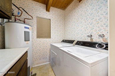 Set on a beautiful 0.52-acre lot surrounded by towering pines on Pinetop Lakes Country Club in Arizona - for sale on GolfHomes.com, golf home, golf lot