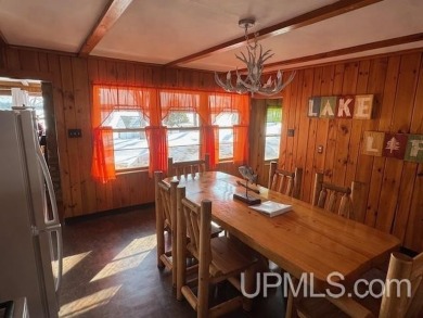 Enjoy the quaint rustic ambience of this northwoods cottage on Wyandotte Hills Golf Course in Michigan - for sale on GolfHomes.com, golf home, golf lot