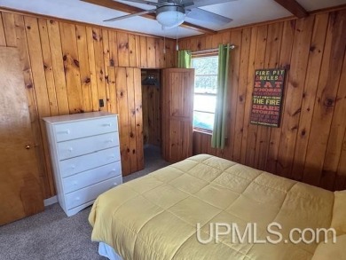 Enjoy the quaint rustic ambience of this northwoods cottage on Wyandotte Hills Golf Course in Michigan - for sale on GolfHomes.com, golf home, golf lot