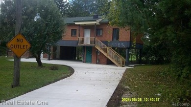 PROPERTY REPAIRED.  BEAUTIFUL CURB APPEAL ON THIS RAISED RANCH on Western Golf and Country Club in Michigan - for sale on GolfHomes.com, golf home, golf lot