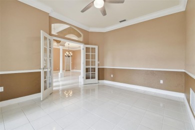 Stunning 4-bedroom, 3-bath pool home with spa on a serene pond on Crescent Oaks Country Club in Florida - for sale on GolfHomes.com, golf home, golf lot