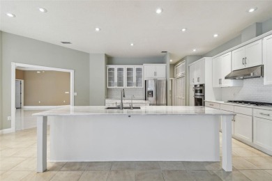 Stunning 4-bedroom, 3-bath pool home with spa on a serene pond on Crescent Oaks Country Club in Florida - for sale on GolfHomes.com, golf home, golf lot
