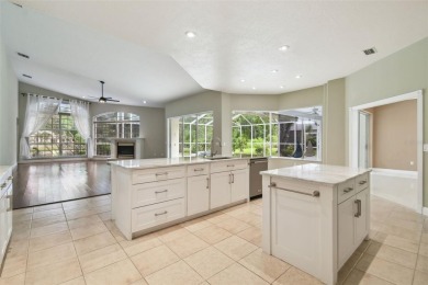Stunning 4-bedroom, 3-bath pool home with spa on a serene pond on Crescent Oaks Country Club in Florida - for sale on GolfHomes.com, golf home, golf lot