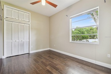 Stunning 4-bedroom, 3-bath pool home with spa on a serene pond on Crescent Oaks Country Club in Florida - for sale on GolfHomes.com, golf home, golf lot