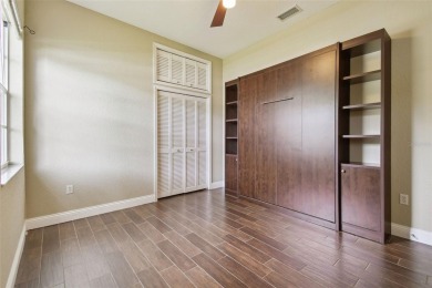 Stunning 4-bedroom, 3-bath pool home with spa on a serene pond on Crescent Oaks Country Club in Florida - for sale on GolfHomes.com, golf home, golf lot