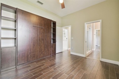 Stunning 4-bedroom, 3-bath pool home with spa on a serene pond on Crescent Oaks Country Club in Florida - for sale on GolfHomes.com, golf home, golf lot
