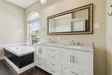 Stunning 4-bedroom, 3-bath pool home with spa on a serene pond on Crescent Oaks Country Club in Florida - for sale on GolfHomes.com, golf home, golf lot