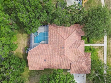 Stunning 4-bedroom, 3-bath pool home with spa on a serene pond on Crescent Oaks Country Club in Florida - for sale on GolfHomes.com, golf home, golf lot