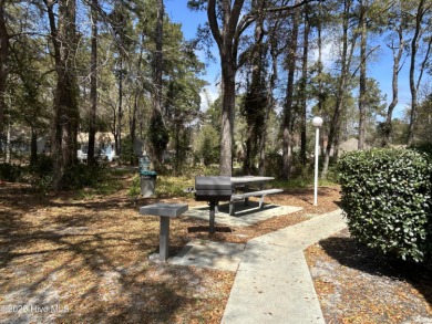 Welcome to this charming 2-bedroom, 2-bathroom coastal condo on Carolina Shores Golf Course in North Carolina - for sale on GolfHomes.com, golf home, golf lot