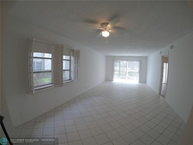 55+ adult community. *CONVENIENT 1ST FLOOR CORNER UNIT WITH on Woodlands Country Club in Florida - for sale on GolfHomes.com, golf home, golf lot