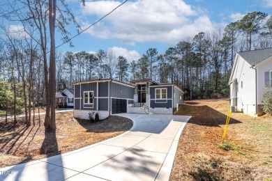 This modern custom-built home in Lake Royale is absolutely on River Golf and County Club at Lake Royale in North Carolina - for sale on GolfHomes.com, golf home, golf lot